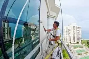 High-rise exterior facade coating on a tall Atlanta tower from a suspended swing stage